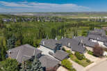 Experience luxury living in this stunning aerial view of a suburban neighborhood, showcasing meticulously designed homes with elegant architecture and spacious layouts.