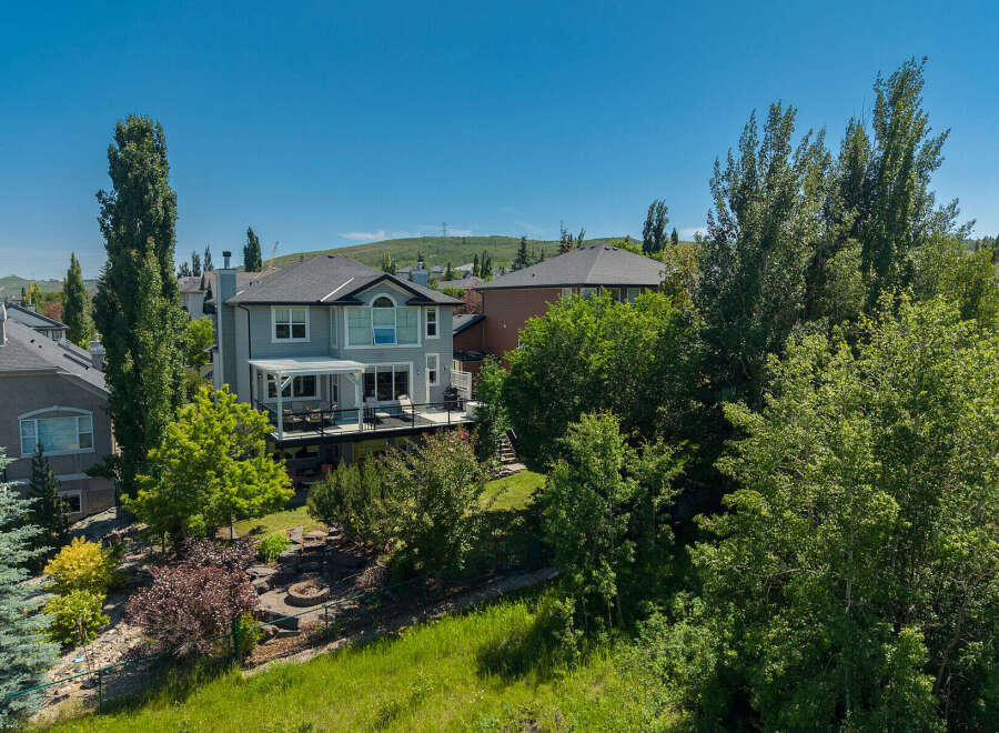 This stunning property boasts a spacious backyard with a multi-level deck, perfect for entertaining guests or enjoying a quiet evening outdoors.