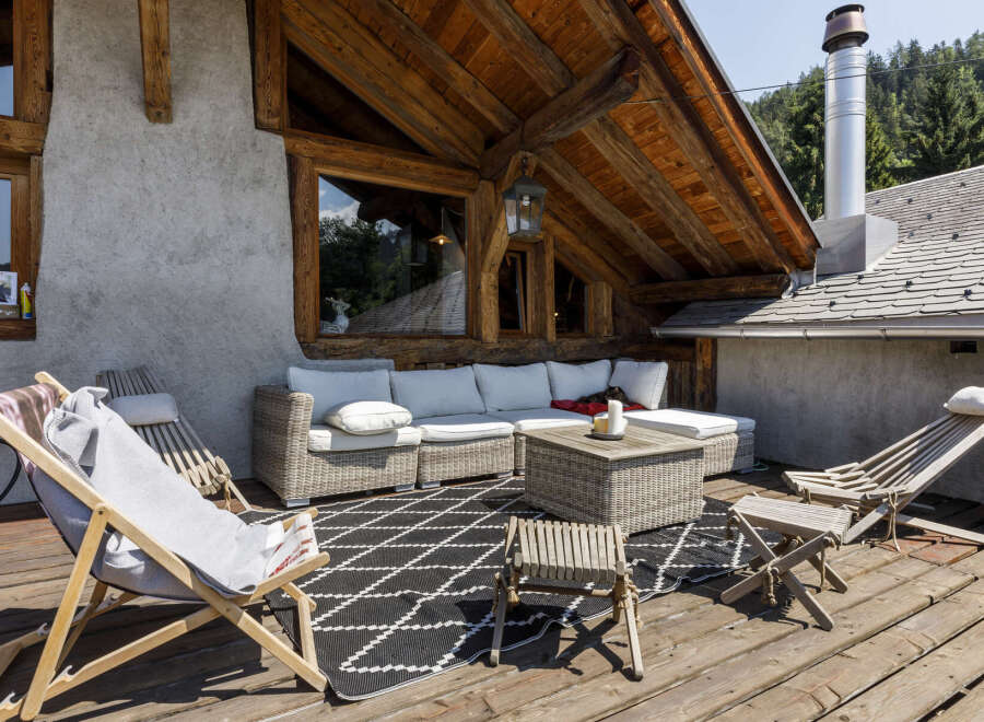 Enjoy the stunning mountain views from this charming wooden chalet's expansive deck, perfect for outdoor living.