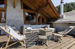 Enjoy the stunning mountain views from this charming wooden chalet's expansive deck, perfect for outdoor living.