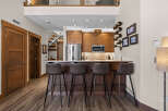Experience modern living in this stunning condo featuring a sleek kitchen with stainless steel appliances and a spacious breakfast bar perfect for entertaining.