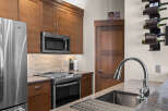 Experience modern living in this beautifully appointed kitchen, featuring sleek stainless steel appliances including a GE refrigerator and microwave.