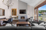 Experience luxury mountain living in this stunning great room, featuring a modern gas fireplace and a sleek entertainment center.