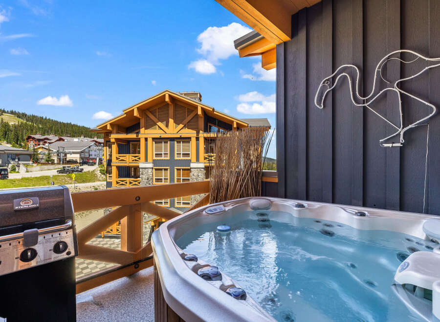 Enjoy ultimate relaxation on this private balcony, complete with a bubbling hot tub and a premium grill, perfect for outdoor entertaining.