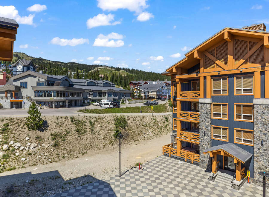 Experience mountain living in this stunning property featuring a modern exterior with stone and wood accents.
