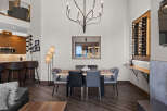 Experience modern living in this stunning dining area, featuring a sleek wooden dining table surrounded by comfortable upholstered chairs.