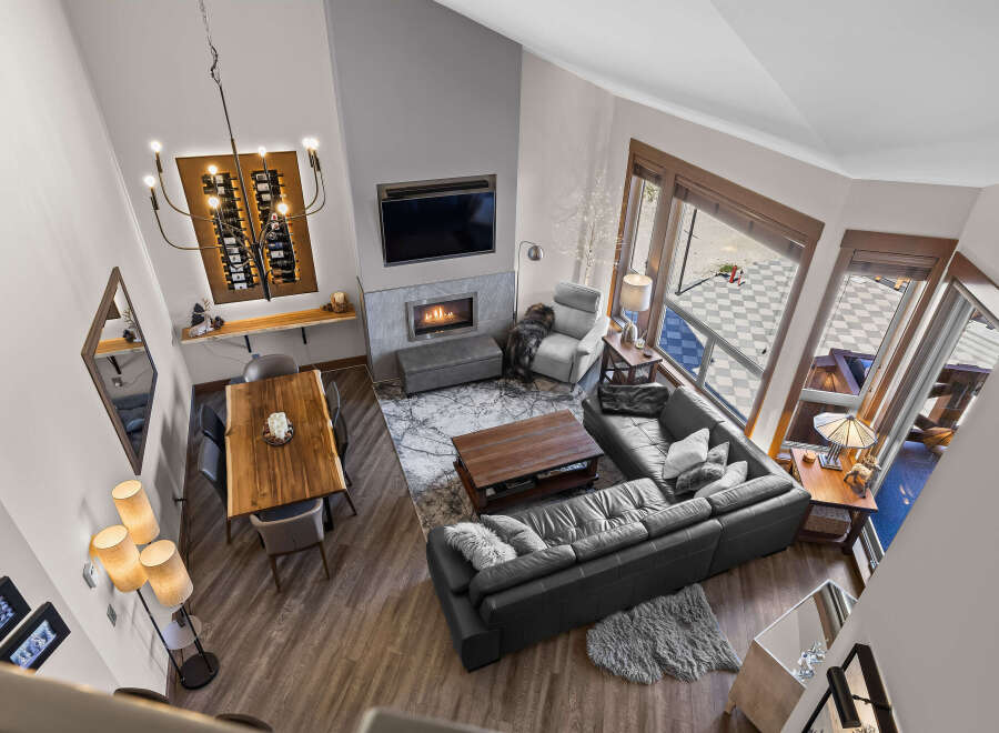 Experience luxury living in this stunning open-concept great room, featuring a soaring vaulted ceiling and a modern gas fireplace.
