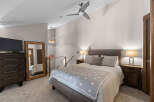 Experience ultimate comfort in this beautifully appointed bedroom, featuring a plush king-sized bed adorned with a charming star-patterned blanket.