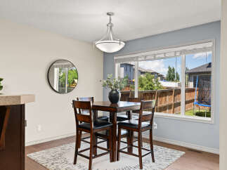 Enjoy casual meals in this charming dining area, featuring a stylish counter-height table and chairs perfect for intimate gatherings.