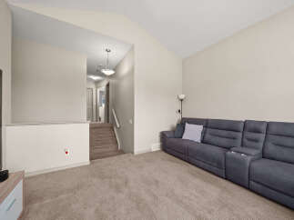 Step into this inviting living space featuring a plush, dark gray sectional sofa perfect for relaxation and entertainment.