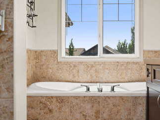 Indulge in relaxation in this luxurious bathroom featuring a deep soaking tub, perfect for unwinding after a long day.