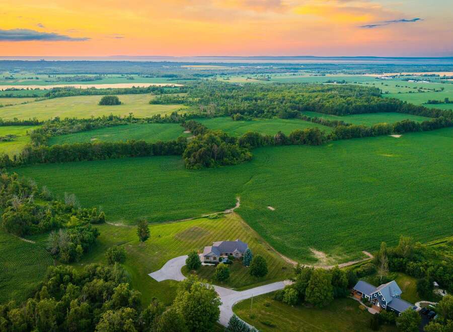 Experience serene country living with this stunning aerial view of a sprawling estate.