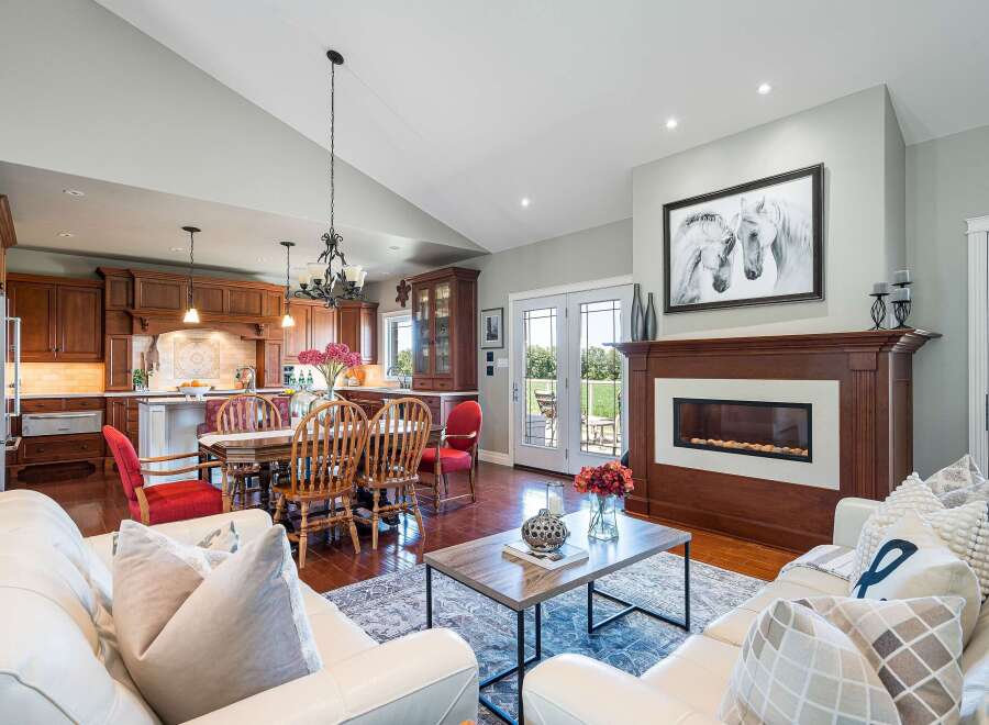 Experience elegant open-concept living in this stunning home, featuring a gourmet kitchen with rich wood cabinetry and a spacious dining area perfect for gatherings.