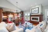 Experience elegant open-concept living in this stunning home, featuring a gourmet kitchen with rich wood cabinetry and a spacious dining area perfect for gatherings.