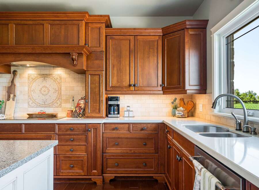 Experience luxury in this stunning kitchen featuring custom cherry wood cabinetry and elegant granite countertops.