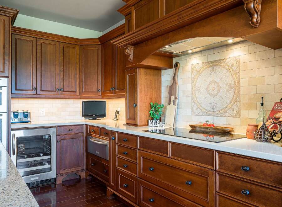 Experience luxury in this stunning kitchen featuring rich, dark wood cabinetry and a sleek, modern induction cooktop.