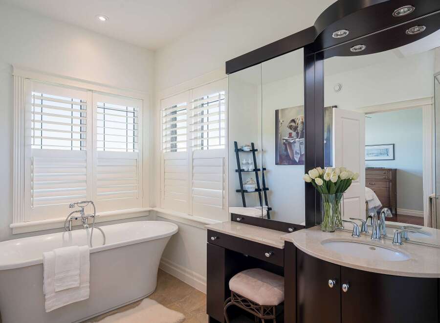 Indulge in luxury in this stunning bathroom featuring a freestanding soaking tub and a spacious vanity with a double sink.
