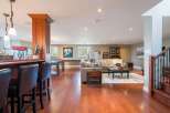 This finished basement offers a perfect blend of entertainment and relaxation, featuring a full-service bar with seating and a dedicated game area with a pool table.