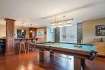 Step into this ultimate entertainment space, featuring a full-service bar with ample seating and a professional-grade pool table perfect for friendly games.