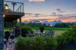 Enjoy breathtaking sunsets from this stunning backyard oasis, complete with a spacious deck and a charming patio set perfect for al fresco dining.