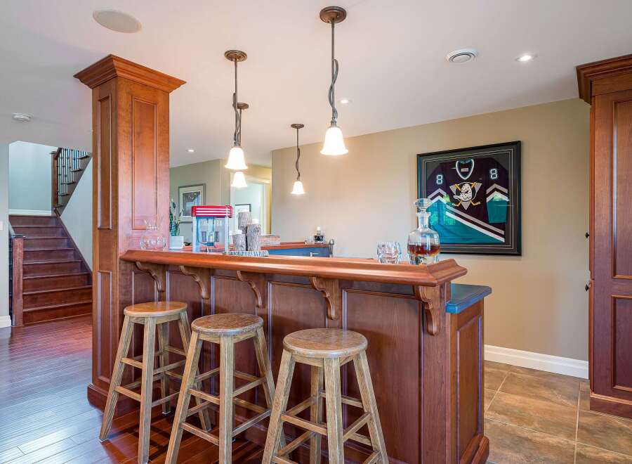 This home features a stunning wooden bar area, perfect for entertaining guests.