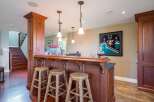 This home features a stunning wooden bar area, perfect for entertaining guests.