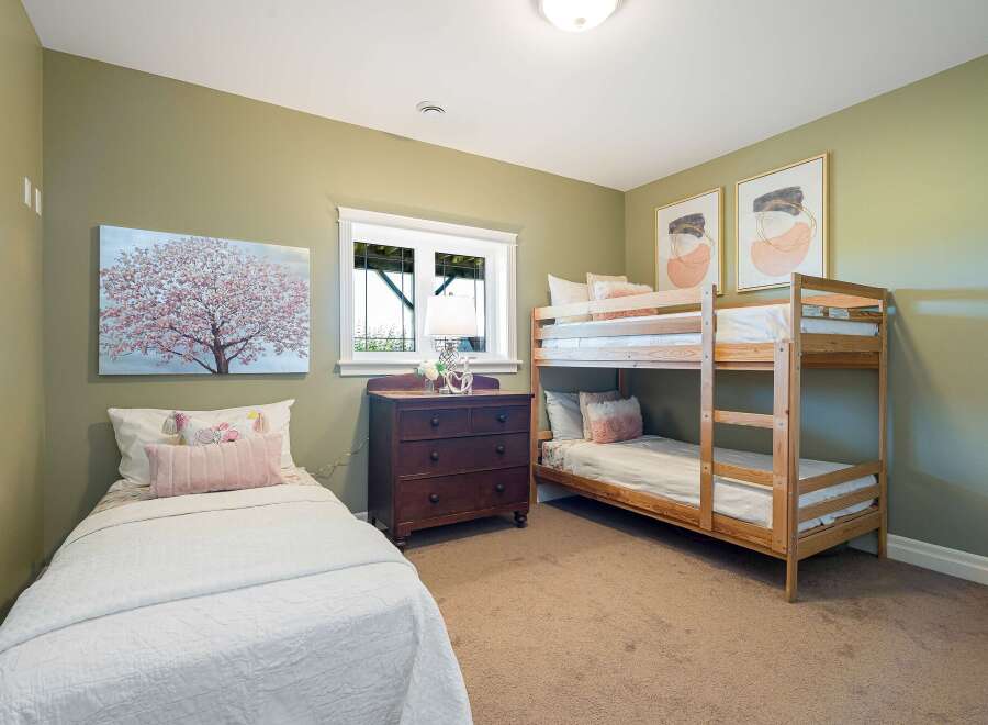 This charming bedroom features a cozy bunk bed and a twin bed, perfect for accommodating family or guests.
