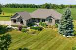 Discover this stunning stone-clad residence nestled amidst picturesque farmland and mature trees.