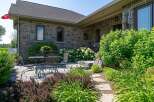 Enjoy outdoor living on this charming stone patio, perfect for al fresco dining or relaxing with a good book.