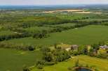Discover this stunning rural estate offering expansive agricultural fields and lush greenery, perfect for those seeking tranquility and space.