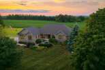 Experience luxurious country living in this stunning stone-clad home, nestled amidst picturesque farmland and mature trees.