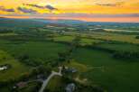 Experience breathtaking sunset views over rolling green fields from this stunning property.