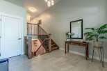 Step into this inviting entryway featuring a modern staircase with dark metal spindles and rich wood accents.