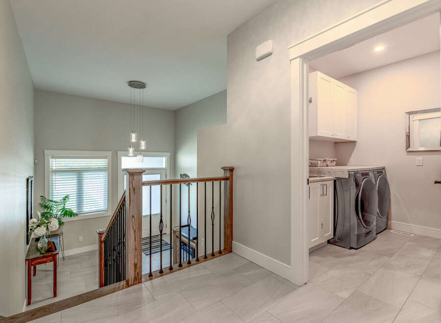 Step into this beautifully designed home, featuring a bright and airy staircase with modern pendant lighting.