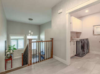 Step into this beautifully designed home, featuring a bright and airy staircase with modern pendant lighting.