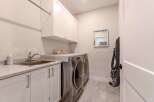 This laundry room features a convenient sink and ample counter space, perfect for folding clothes.