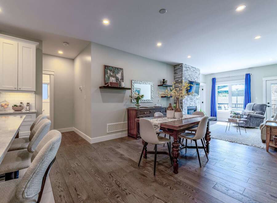 Experience modern living in this beautifully appointed open-concept space, featuring a gourmet kitchen with sleek cabinetry and a marble-topped island perfect for casual dining.