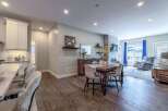 Experience modern living in this beautifully appointed open-concept space, featuring a gourmet kitchen with sleek cabinetry and a marble-topped island perfect for casual dining.