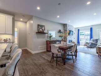 Experience modern living in this beautifully appointed open-concept space, featuring a gourmet kitchen with sleek cabinetry and a marble-topped island perfect for casual dining.