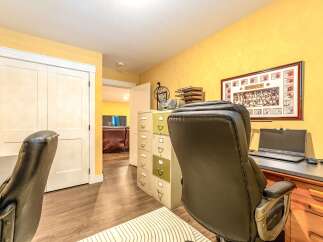 This home office features a bright yellow accent wall, perfect for inspiring creativity and productivity.