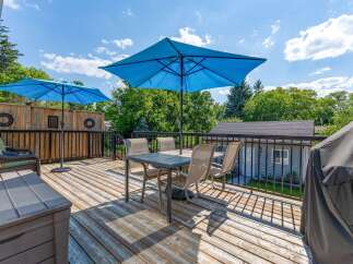 Enjoy outdoor living on this spacious wooden deck, perfect for entertaining or relaxing.