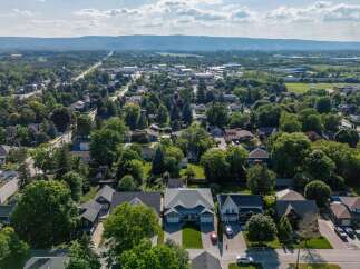 Discover this charming suburban neighborhood with beautiful homes nestled amongst mature trees.