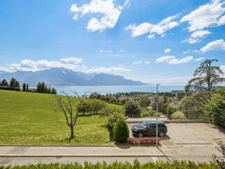 Experience breathtaking panoramic views of the lake and mountains from this stunning property.