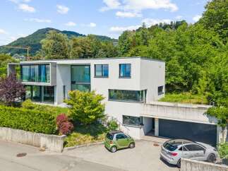 Discover modern luxury in this stunning multi-level home, boasting expansive glass windows and sleek architectural lines.
