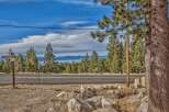 Discover your dream mountain retreat with stunning lake views! This prime location offers a serene escape surrounded by towering pine trees and a picturesque landscape.