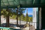 Enjoy breathtaking lake and mountain views from this property's covered porch, perfect for relaxing or entertaining.