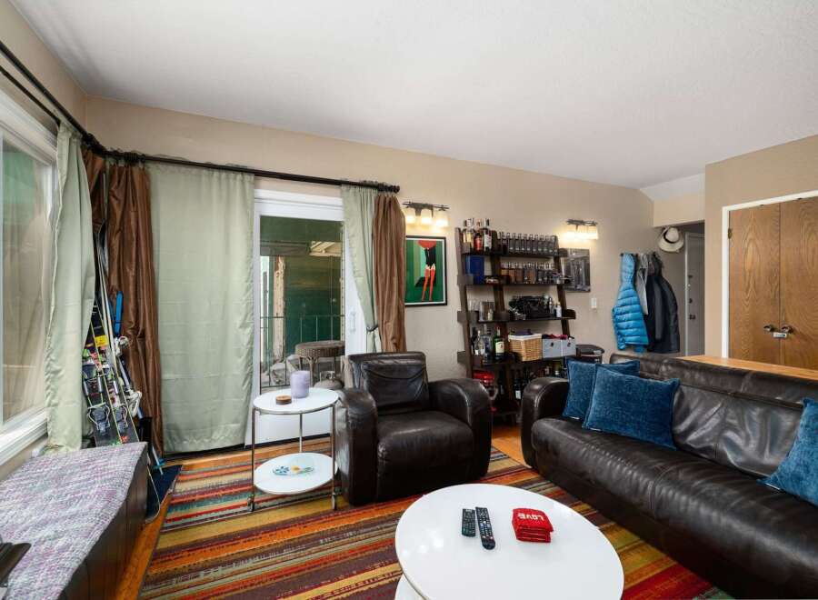 This cozy living room features a rich leather sofa and armchair, perfect for relaxing.