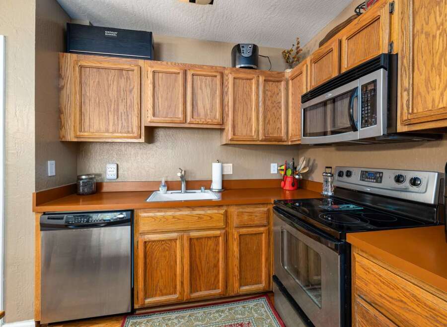This cozy kitchen features warm, honey-toned wood cabinetry that provides ample storage.