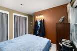This cozy bedroom features a comfortable bed with a light blue quilted comforter, perfect for restful nights.