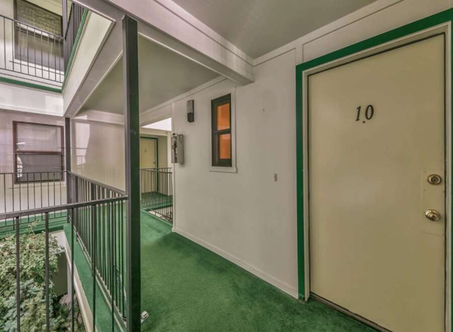 Discover this charming apartment complex with a welcoming outdoor walkway leading to unit 10.